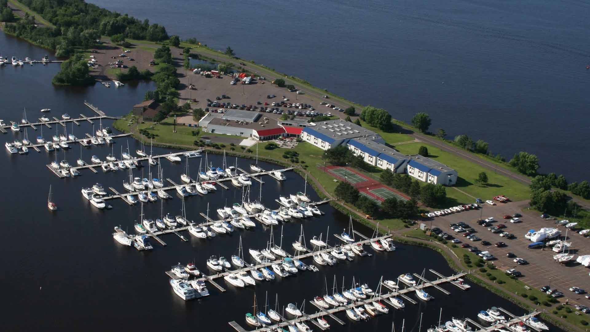 A birds-eye view of the Barkers Island Inn. The hotel is on the center of the island and is surrounded by sailboats on the marina.