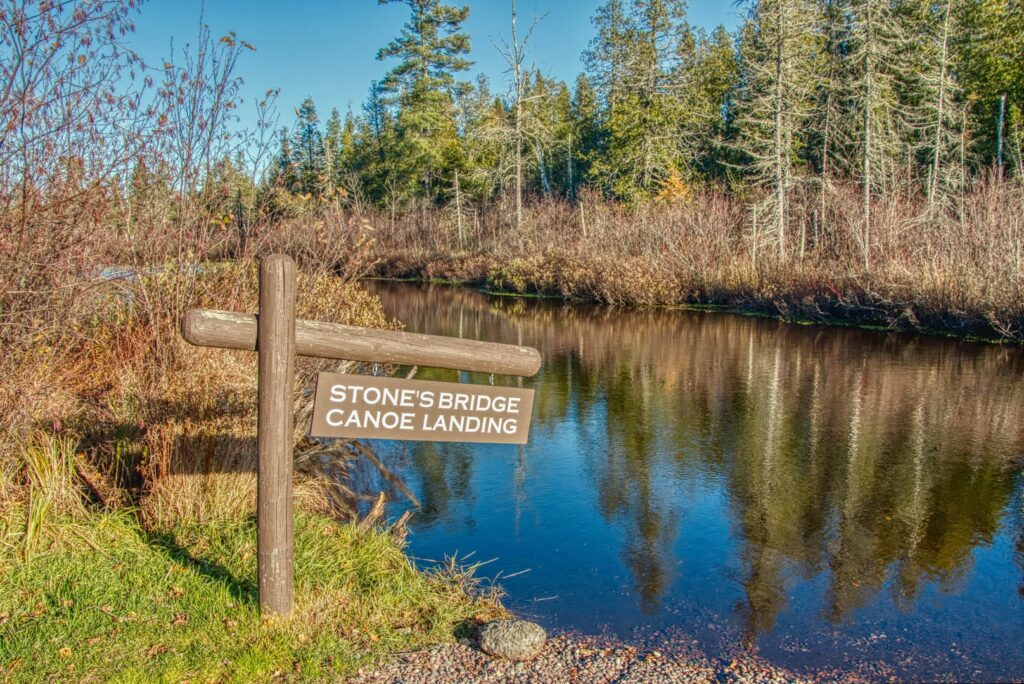 A canoe landing with a sign that reads 