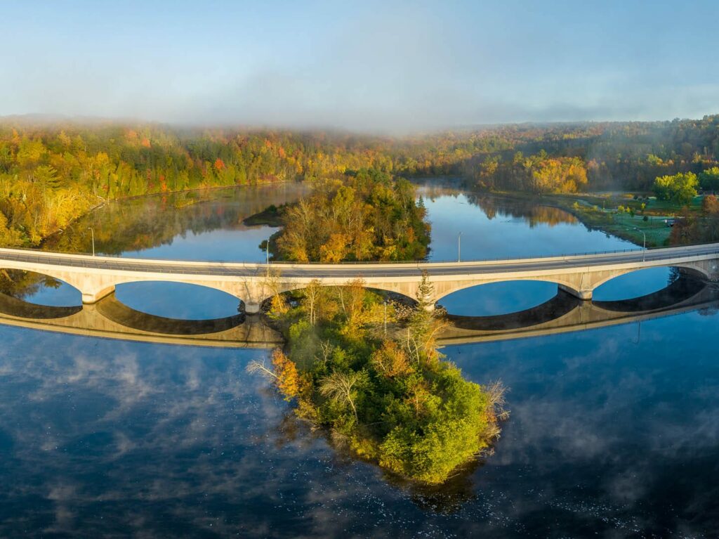 Highway 23 bridge and all of its arches over a very blue st. louis river in the autumn. The fall colors are beautiful. Photo by Dennis O'Hara.