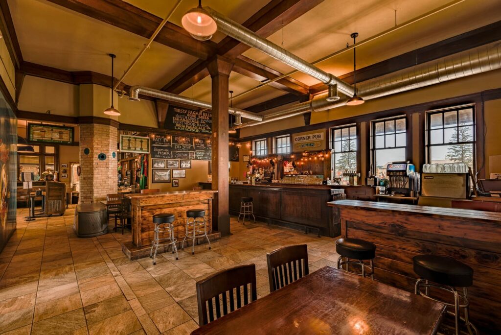 Interior of Thirsty Pagan Brewing. There is a bar and many wooden tables.