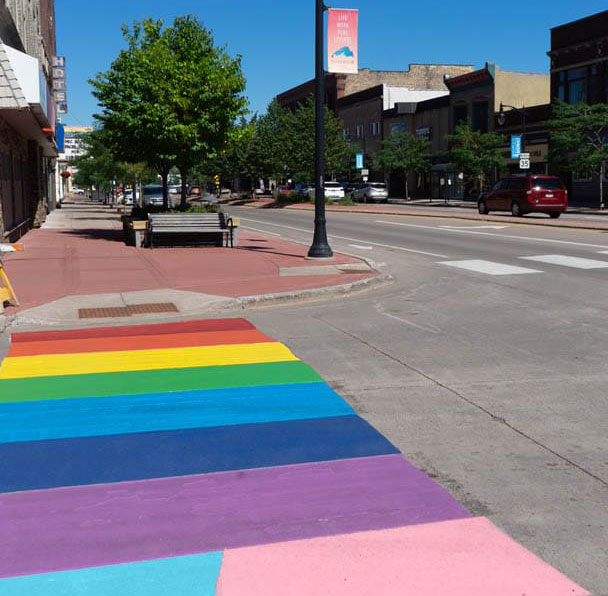 A painted rainbow crossing along Tower Avenue shows the city's pride.