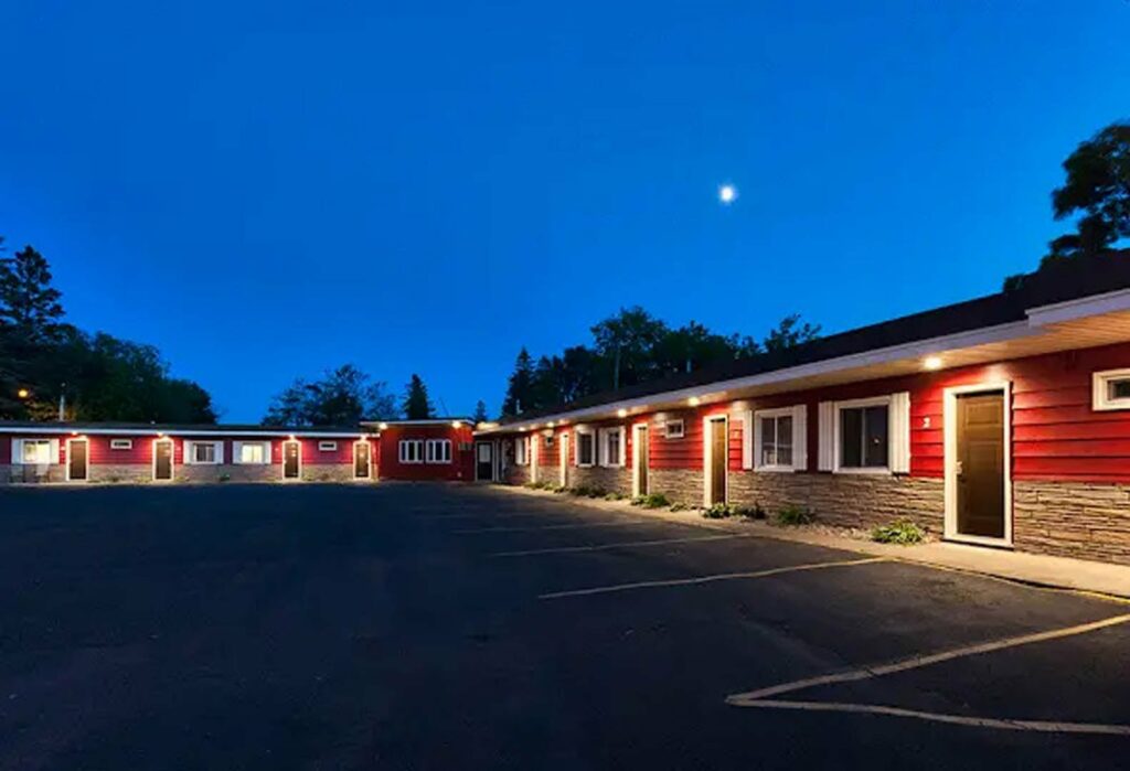 The single story Superior Bay Motel at dusk.