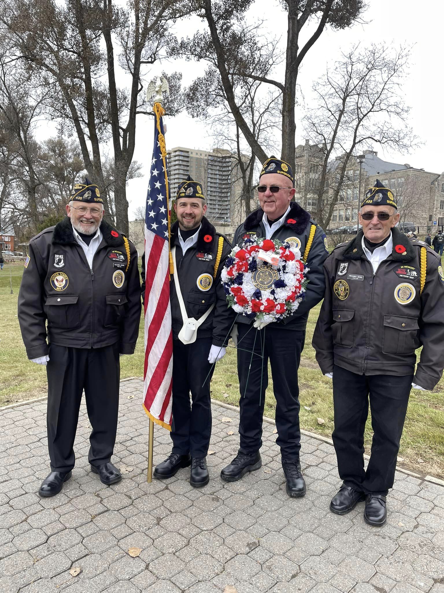 Four male veterans at a memorial day ceremony.