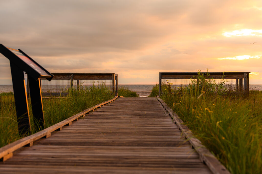 A wooden boardwalk in the early morning that takes you to the and beach at Wisconsin Point 