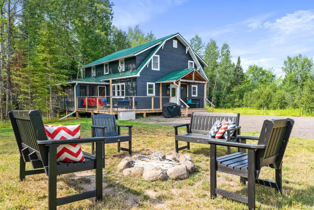Shot of the Brule River Barn with an outdoor fire pit with chairs.