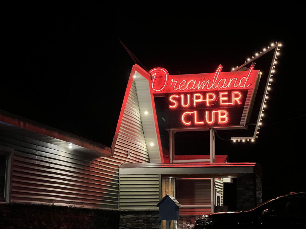 Dreamland Supper Club neon sign at night.