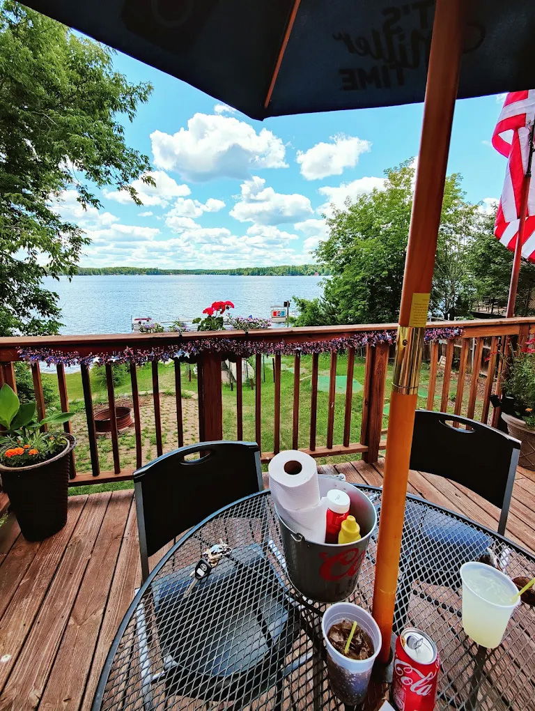 View of a lake from a deck at a lakeside eatery.