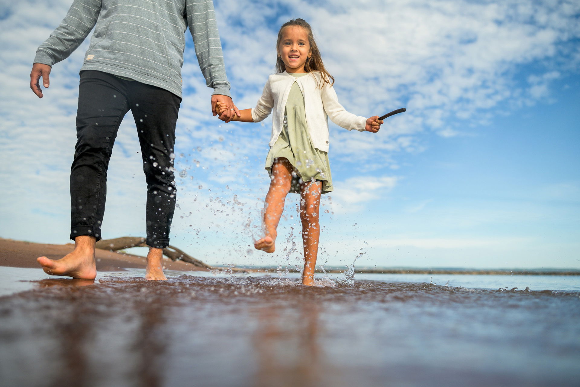 A girl running through water embodies the joy of summer activities in Superior, Wisconsin.