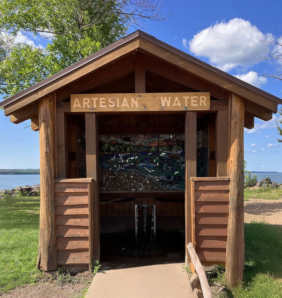 A wooden structure with a sign, perfect for enjoying summer activities in Superior Wisconsin.