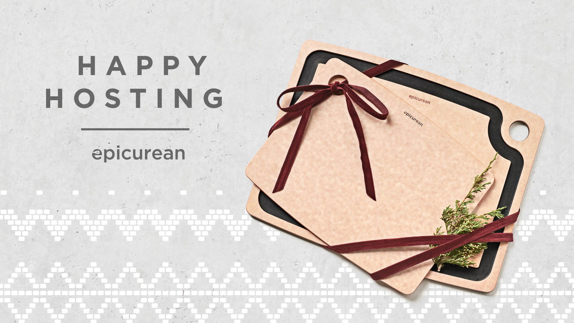 Two tan cutting boards with maroon ribbon and sprigs of greenery rest on a black cutting board. On the left, text reads: "HAPPY HOSTING epicurean" against a light grey background with a geometric border.