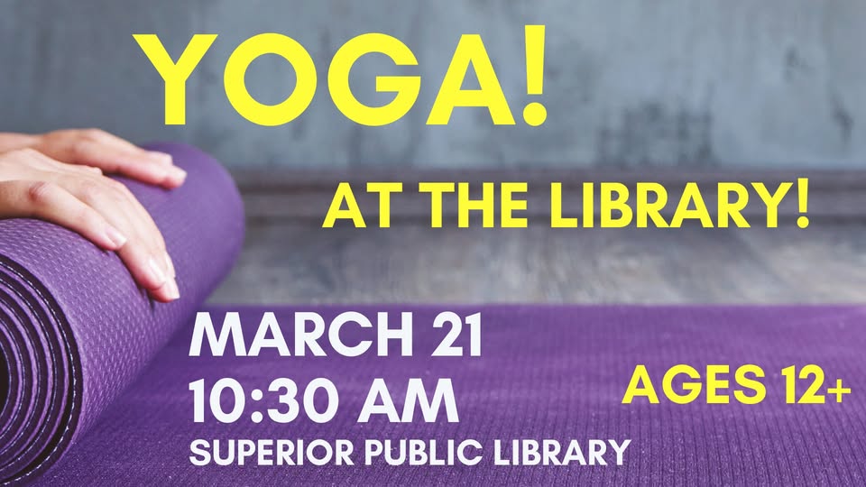 Close-up of a hand rolling up a purple yoga mat. Text reads: "YOGA! AT THE LIBRARY! March 21, 10:30 AM, Superior Public Library, Ages 12+." Background shows a wooden floor and gray wall.