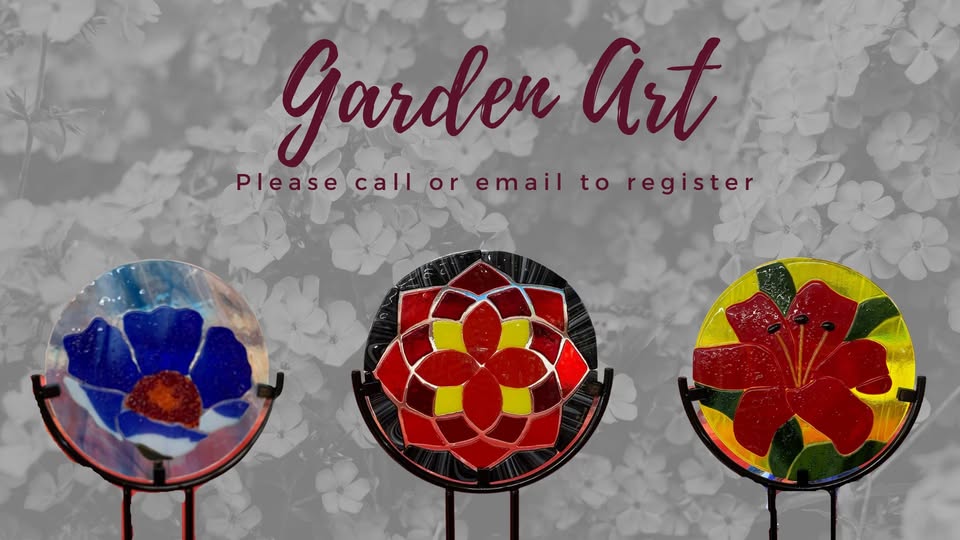 Three colorful stained glass flower art pieces on stands, set against a grayscale floral background. Text above reads: "Garden Art. Please call or email to register.
