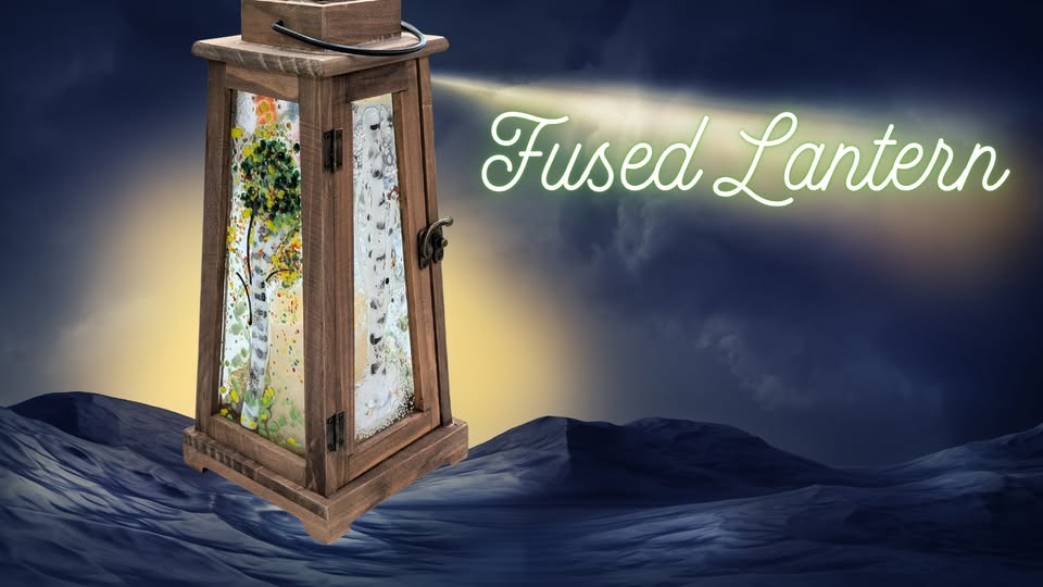 A wooden lantern with colorful fused glass panels stands on a blue landscape at night, casting light toward the glowing words "Fused Lantern" in the sky.