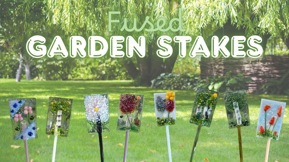 Colorful fused glass garden stakes are displayed outdoors, each decorated with unique floral and nature designs, set against a lush green garden background with large text reading "Fused Garden Stakes" above.