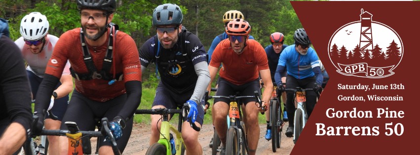 A group of cyclists ride on a dirt trail in a forested area. An event banner on the right reads, “Saturday, June 13th, Gordon, Wisconsin, Gordon Pine Barrens 50,” with a logo of a tower and trees.