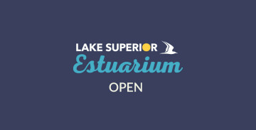 Text on a blue background reads: "Lake Superior Estuarium OPEN." The word "Superior" includes a yellow circle as the "O," and a white bird graphic is to the right of it.
