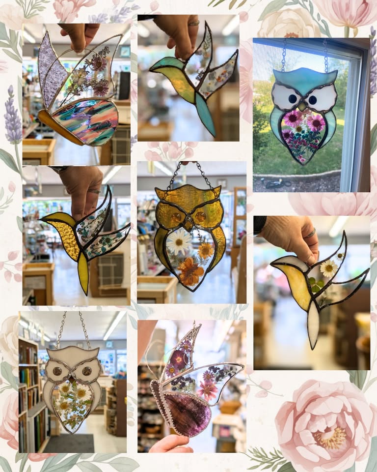 Collage of stained glass art pieces shaped like owls and birds, some featuring pressed flowers, displayed in a shop with books and floral wallpaper in the background.
