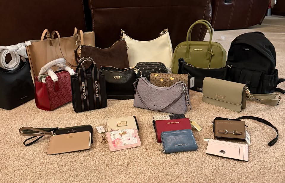 A collection of various handbags, shoulder bags, and wallets arranged on a carpeted floor.